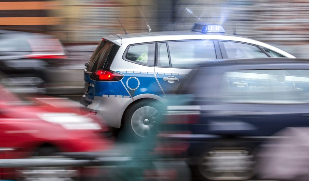 german police car speeding in city traffic