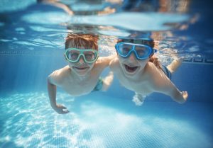 Little brothers swinning underwater together